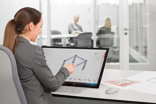 A woman planning a modular construction on a computer.