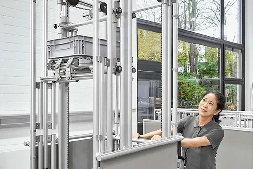 A man assembling a modular machine enclosure.