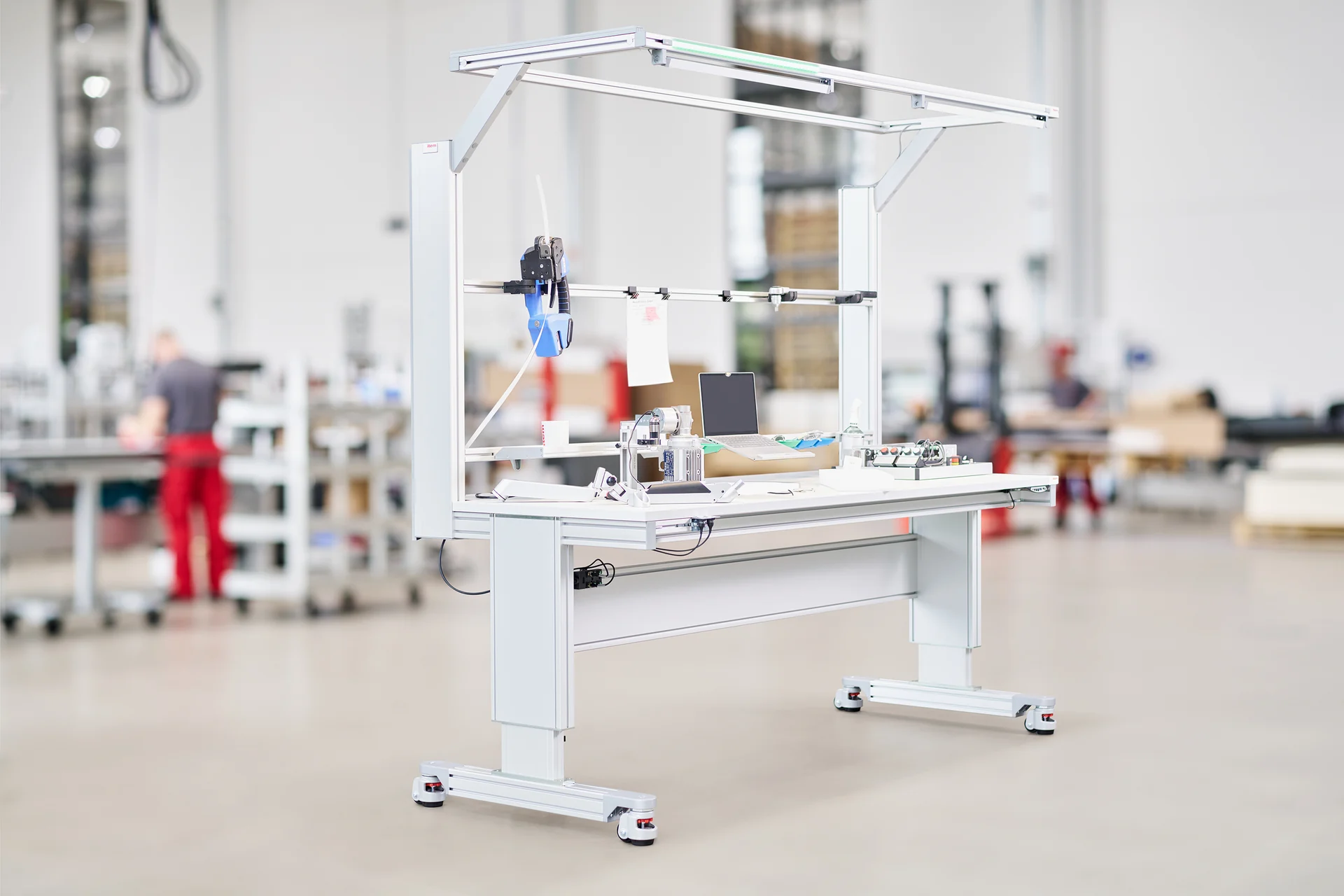 Height-adjustable industrial item work bench with storage and lighting